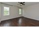 Spacious bedroom with hardwood floors and large windows, providing ample natural light and a warm, inviting atmosphere at 723 Lindley Dr, Durham, NC 27703