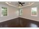 Bright bedroom features tray ceiling, hardwood floors, and generous natural light from multiple windows at 723 Lindley Dr, Durham, NC 27703