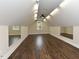 Expansive bonus room with hardwood floors, mirrors, and ample lighting, perfect for a fitness area or recreational space at 723 Lindley Dr, Durham, NC 27703