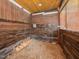 The interior of the chicken coop with wood paneling, flooring and feeders to give the chickens a great place to live at 723 Lindley Dr, Durham, NC 27703