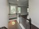 Bright hallway with staircase and stylish railing, seamlessly connecting different levels of the home with natural light at 723 Lindley Dr, Durham, NC 27703
