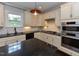 Well-lit kitchen features granite counters, stainless steel appliances, and white subway tile backsplash at 723 Lindley Dr, Durham, NC 27703