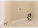 Functional laundry room with utility connections and bright tile flooring offering practical convenience and easy maintenance at 723 Lindley Dr, Durham, NC 27703