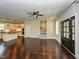 Spacious living room features hardwood floors, ceiling fan, and staircase near kitchen at 723 Lindley Dr, Durham, NC 27703