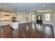 Open-concept living room with hardwood floors connects to kitchen, creating a spacious gathering area at 723 Lindley Dr, Durham, NC 27703