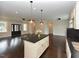 Spacious open floor plan with a kitchen island, hardwood floors, and an abundance of natural light at 723 Lindley Dr, Durham, NC 27703