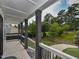 Covered porch offers a serene outdoor space overlooking a well-manicured lawn and mature trees at 723 Lindley Dr, Durham, NC 27703