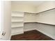 Spacious walk-in closet with custom shelving and dark hardwood floors, offering ample storage and organization space at 723 Lindley Dr, Durham, NC 27703