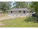 Backyard of house with grass, new fence, and a view of the back of the home at 768 Lunar Dr, Raleigh, NC 27610