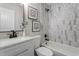 Updated bathroom featuring custom wall tile, modern fixtures, and decor at 768 Lunar Dr, Raleigh, NC 27610