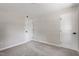 Bright bedroom featuring neutral paint and carpet, with white doors and black hardware at 768 Lunar Dr, Raleigh, NC 27610