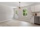 Dining area with modern light fixture and new cabinets is adjacent to the kitchen area at 768 Lunar Dr, Raleigh, NC 27610