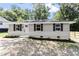 Charming single story home with gray siding, black shutters, and freshly landscaped front yard at 768 Lunar Dr, Raleigh, NC 27610