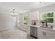 Open concept kitchen with stainless steel appliances, quartz countertops, and modern lighting at 768 Lunar Dr, Raleigh, NC 27610