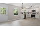 Modern kitchen features stainless appliances, white cabinets, and stylish lighting at 768 Lunar Dr, Raleigh, NC 27610