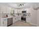 Contemporary kitchen boasts white cabinets, stainless steel appliances, and stylish subway tile backsplash at 768 Lunar Dr, Raleigh, NC 27610