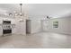 Open concept living room and kitchen featuring new flooring, modern lighting, and white cabinets at 768 Lunar Dr, Raleigh, NC 27610