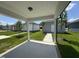 Covered patio overlooking a well-manicured lawn, newly planted trees, and matching detached garages at 805 Portland Rose Dr, Knightdale, NC 27545