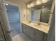 Bright bathroom featuring double vanity, quartz countertop, modern fixtures and a glass enclosed shower at 805 Portland Rose Dr, Knightdale, NC 27545