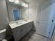 Bathroom with double sink vanity, large mirror, modern lighting, and white quartz countertop at 805 Portland Rose Dr, Knightdale, NC 27545