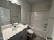 Bathroom featuring a white vanity with modern fixtures and a bathtub with shower at 805 Portland Rose Dr, Knightdale, NC 27545