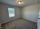 Bedroom with plush carpeting, a window for natural light, and a closet at 805 Portland Rose Dr, Knightdale, NC 27545