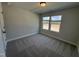 Cozy bedroom featuring soft carpeting and a bright window providing natural light at 805 Portland Rose Dr, Knightdale, NC 27545