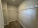 Walk-in closet features neutral walls and carpet, with plenty of shelving for optimal storage at 805 Portland Rose Dr, Knightdale, NC 27545