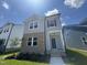 Charming two-story home with a combination of brick and siding on a beautiful lawn with a clear blue sky at 805 Portland Rose Dr, Knightdale, NC 27545