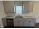 Kitchen featuring a stainless steel dishwasher, granite countertops and gray cabinets at 805 Portland Rose Dr, Knightdale, NC 27545