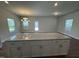 Kitchen featuring an island, granite countertops, and gray cabinets with a view to the backyard at 805 Portland Rose Dr, Knightdale, NC 27545