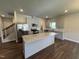 Kitchen featuring an island, stainless steel appliances, and gray cabinets with under-cabinet lighting at 805 Portland Rose Dr, Knightdale, NC 27545