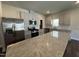 Modern kitchen features stainless steel appliances, granite countertops, and stylish gray cabinetry at 805 Portland Rose Dr, Knightdale, NC 27545