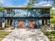 Modern home with a shared driveway, gray siding, and two-car garages with wooden doors at 805 Tower St, Raleigh, NC 27607