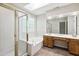 Bright bathroom with soaking tub, walk-in shower, vanity with dual sinks, and skylight at 809 Green Passage Ln, Apex, NC 27502