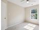 Bedroom featuring neutral walls, plush carpeting, ceiling fan, and a window with a bright view at 809 Green Passage Ln, Apex, NC 27502