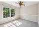 Bedroom featuring neutral walls, plush carpeting, and a window with bright green outdoor views at 809 Green Passage Ln, Apex, NC 27502