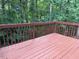 A wood deck with stained wood railing overlooks a dense green forest at 809 Green Passage Ln, Apex, NC 27502