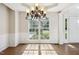 Open dining area with stylish chandelier and views of the front yard at 809 Green Passage Ln, Apex, NC 27502
