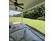 Covered back patio with ceiling fan overlooks large backyard and wooded area at 820 Christian Light Rd, Fuquay Varina, NC 27526