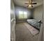 Cozy bedroom featuring neutral walls, carpet floors, ample natural light, and a ceiling fan at 820 Christian Light Rd, Fuquay Varina, NC 27526