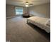 Spacious bedroom with carpet floors, a large window offering a scenic view, and comfortable sitting area at 820 Christian Light Rd, Fuquay Varina, NC 27526