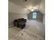 Versatile bonus room featuring vaulted ceilings, plush carpet, a ceiling fan, and comfortable seating area at 820 Christian Light Rd, Fuquay Varina, NC 27526