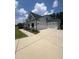 Spacious three-car garage featuring white doors, a wide concrete driveway, and well-maintained landscaping at 820 Christian Light Rd, Fuquay Varina, NC 27526