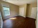 A bedroom has a window, closet, and door with neutral paint and wood-look flooring at 8228 Clarks Branch Dr, Raleigh, NC 27613