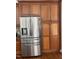 Stainless steel refrigerator with cabinets to the side offer great storage in this kitchen at 8228 Clarks Branch Dr, Raleigh, NC 27613