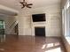 Open-concept living room featuring a fireplace and built-in shelving at 8228 Clarks Branch Dr, Raleigh, NC 27613