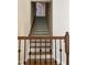 Staircase with wood railing and black metal balusters at 8228 Clarks Branch Dr, Raleigh, NC 27613