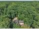 Aerial view of a charming house with mature trees and lush greenery, providing a serene atmosphere at 8510 Dunlee Falls Rd, Raleigh, NC 27613