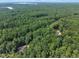 Wonderful location with lush greenery, mature trees, and a serene setting visible in this property's aerial view at 8510 Dunlee Falls Rd, Raleigh, NC 27613